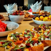 a table topped with plates of food and bowls of fruit