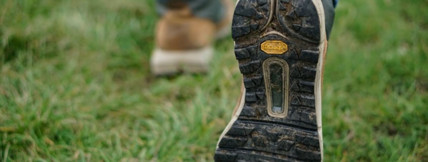 person wearing brown-and-black shoes