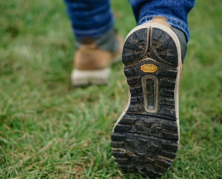 person wearing brown-and-black shoes