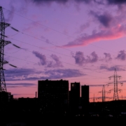 silhouette of buildings under cloudy sky during sunset
