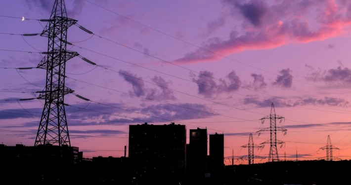 silhouette of buildings under cloudy sky during sunset