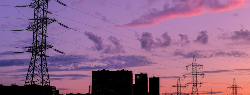 silhouette of buildings under cloudy sky during sunset