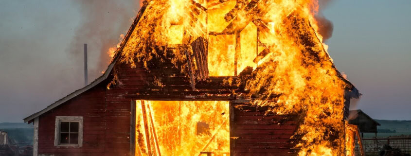 brown wooden house near fire